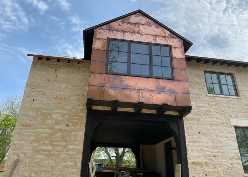 Copper metal panel facade on a stone building for Roof Repair in Dyersburg